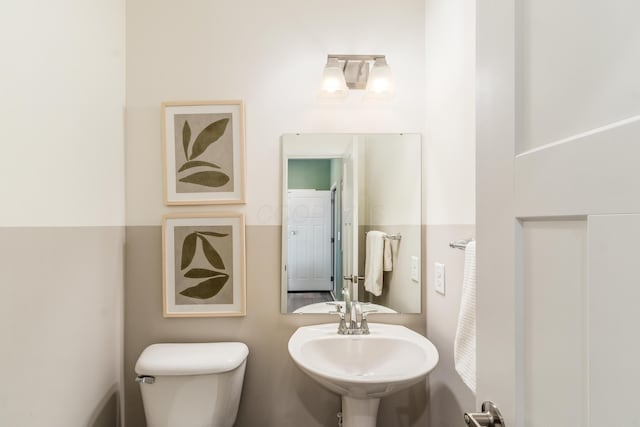 bathroom with toilet and a sink