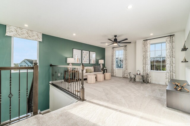 carpeted living room with ceiling fan, recessed lighting, and baseboards