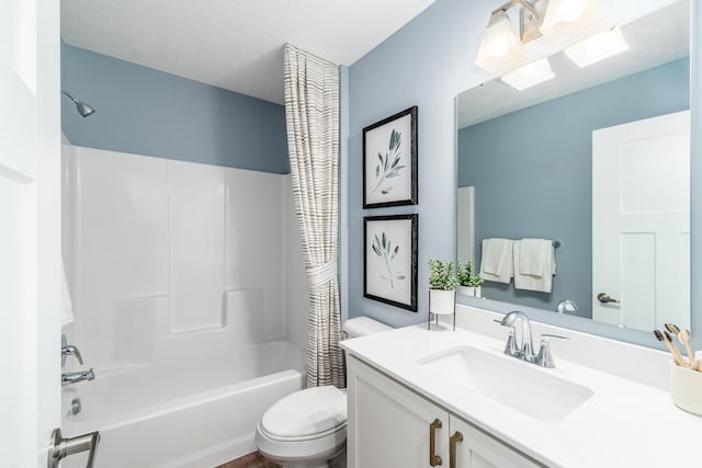 bathroom with shower / bath combo with shower curtain, toilet, and vanity