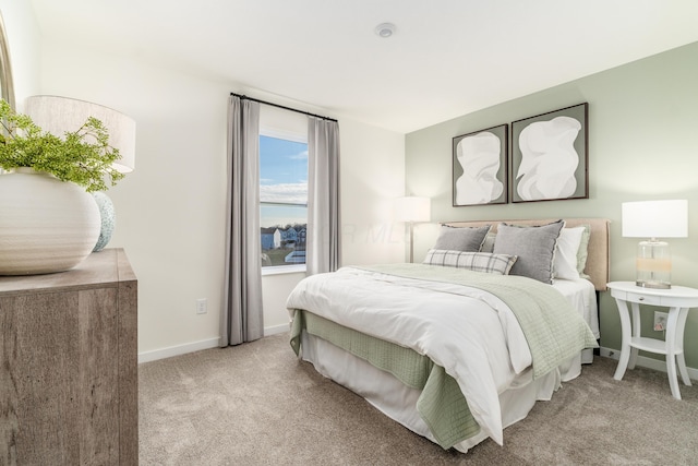 bedroom featuring baseboards and light carpet