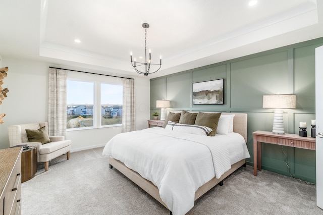 bedroom with recessed lighting, light carpet, an inviting chandelier, and a tray ceiling
