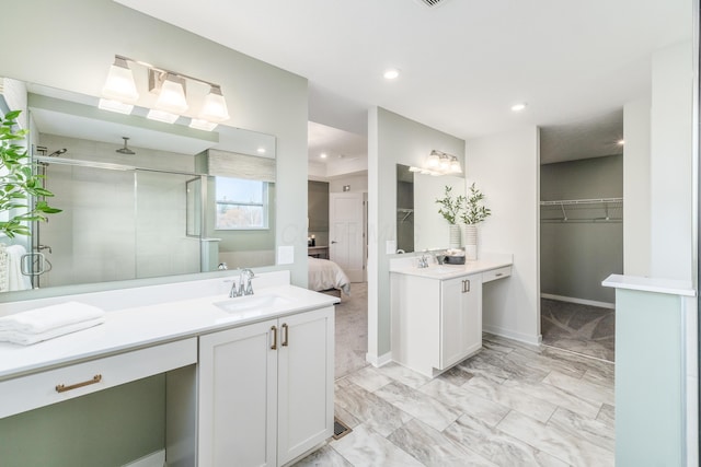 bathroom with recessed lighting, a shower stall, marble finish floor, vanity, and baseboards