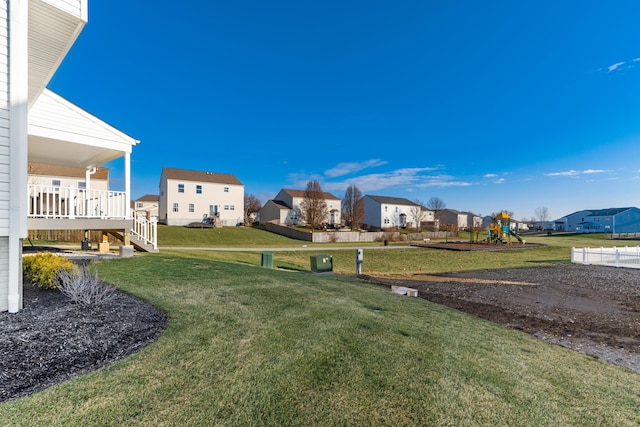 view of yard featuring a residential view and playground community