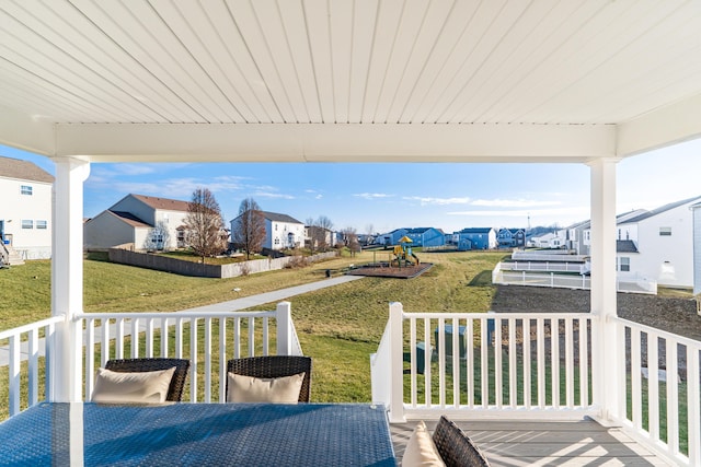 wooden deck with a residential view and a yard