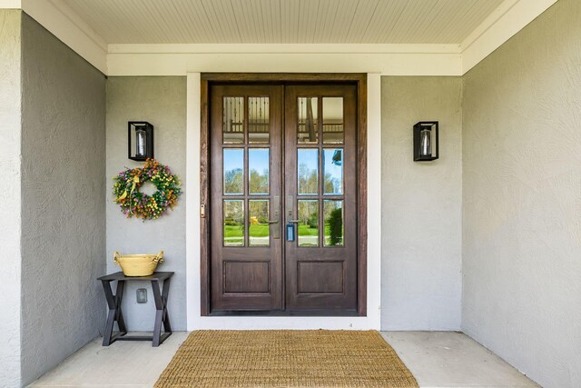 doorway to property with stucco siding and french doors