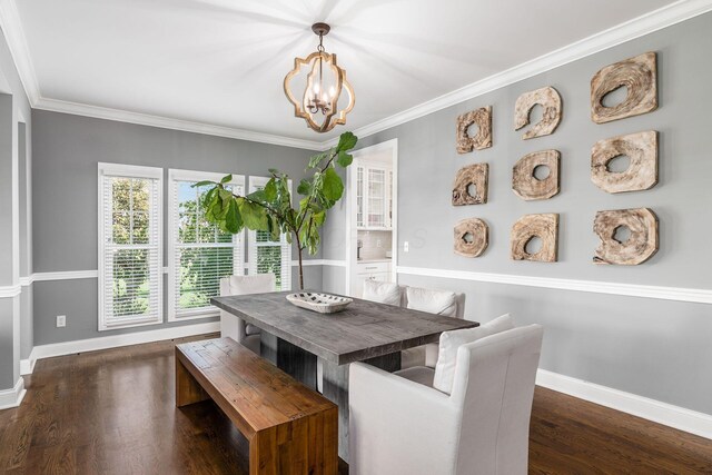 dining space featuring crown molding, baseboards, an inviting chandelier, and dark wood finished floors