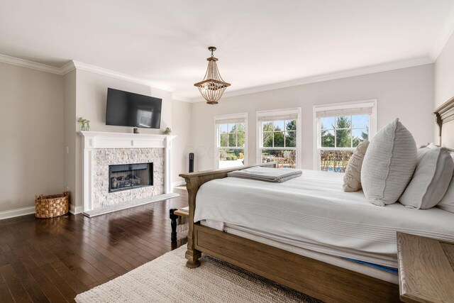 bedroom with crown molding, multiple windows, and dark wood-style floors