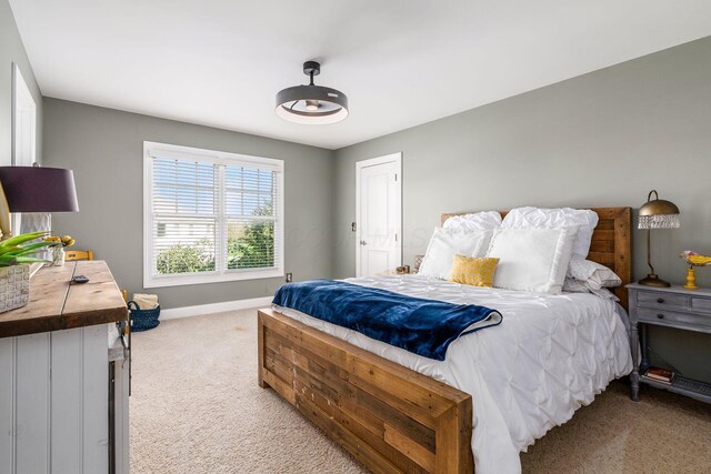 carpeted bedroom featuring baseboards