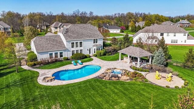 outdoor pool featuring a gazebo and a lawn