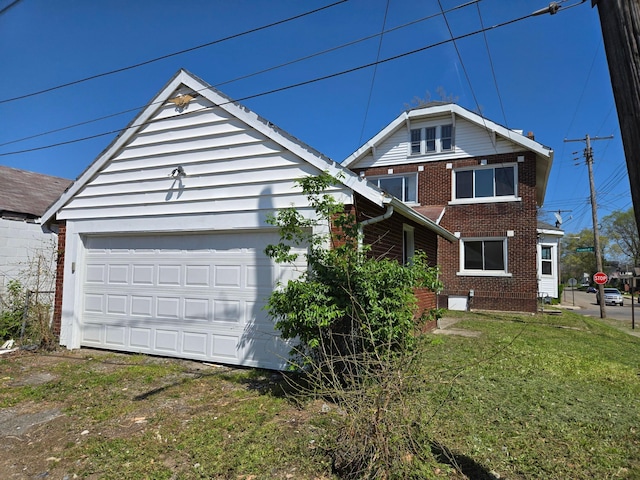 view of front facade with brick siding and a front yard