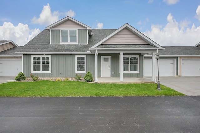 108 Cumberland Meadows Cir, Hebron, OH 43025 - view of front of house featuring concrete driveway, a porch, an attached garage, a front lawn, and a shingled roof