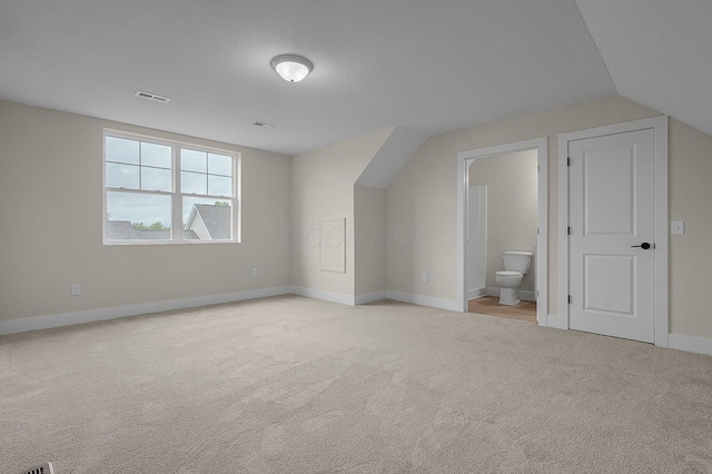 108 Cumberland Meadows Cir, Hebron, OH 43025 - bonus room featuring light colored carpet, baseboards, and vaulted ceiling