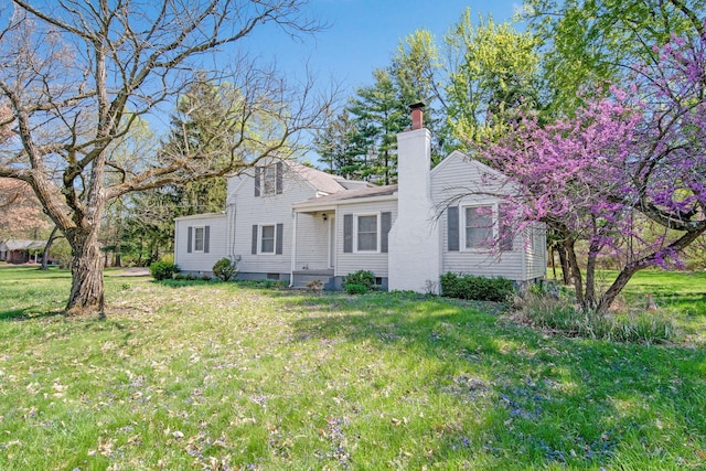 2575 Jordan Rd, Columbus, OH 43231 - back of house featuring a chimney and a yard