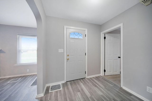 2575 Jordan Rd, Columbus, OH 43231 - foyer entrance featuring a wealth of natural light, wood finished floors, visible vents, and arched walkways