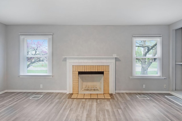 2575 Jordan Rd, Columbus, OH 43231 - unfurnished living room with a fireplace, wood finished floors, visible vents, and baseboards