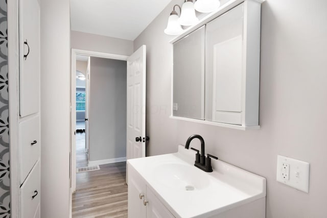 2575 Jordan Rd, Columbus, OH 43231 - bathroom with baseboards, vanity, and wood finished floors