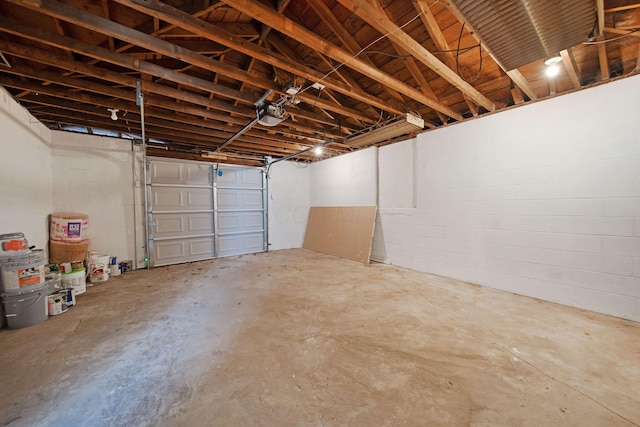 2575 Jordan Rd, Columbus, OH 43231 - garage featuring a garage door opener and concrete block wall