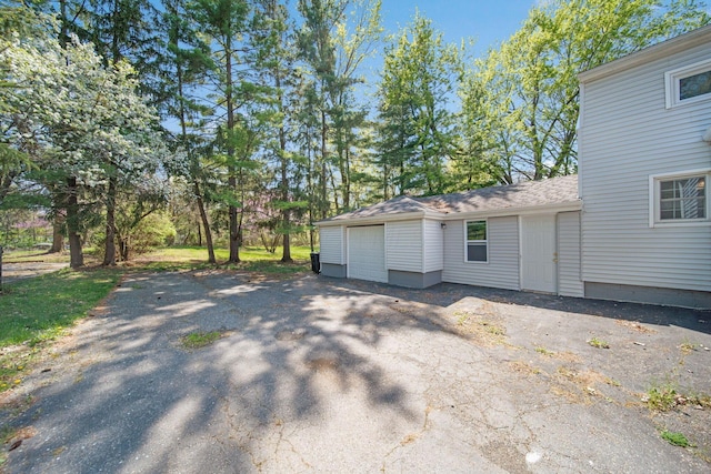 2575 Jordan Rd, Columbus, OH 43231 - view of side of home featuring a garage and aphalt driveway