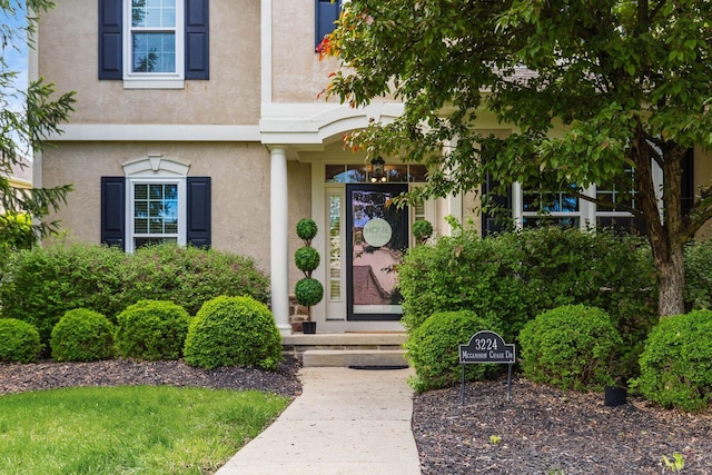 entrance to property featuring stucco siding