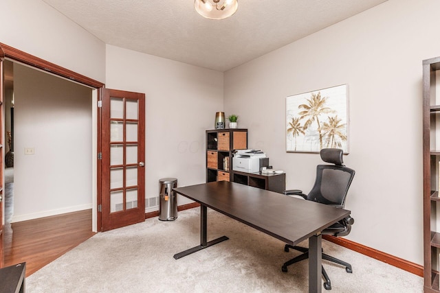 office with baseboards, wood finished floors, and french doors