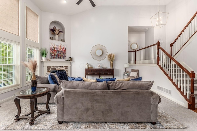 living room featuring visible vents, baseboards, stairs, and lofted ceiling