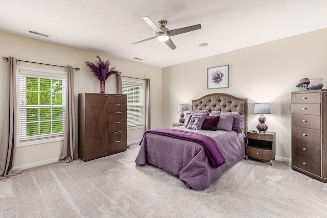bedroom featuring carpet floors, baseboards, visible vents, and multiple windows
