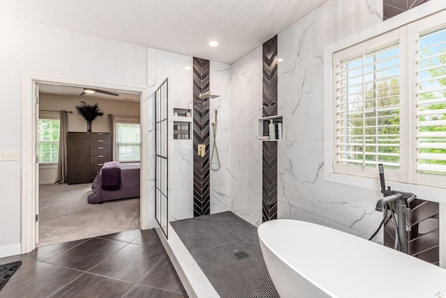 full bathroom with a freestanding bath, plenty of natural light, and a marble finish shower