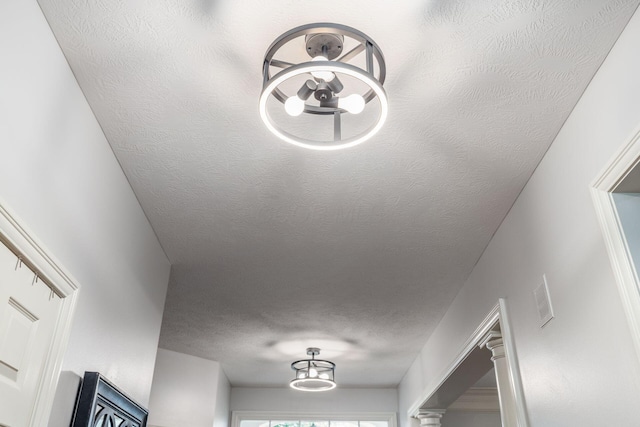 room details with a textured ceiling, a chandelier, and visible vents