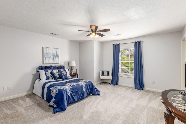 bedroom with a ceiling fan, baseboards, visible vents, and carpet