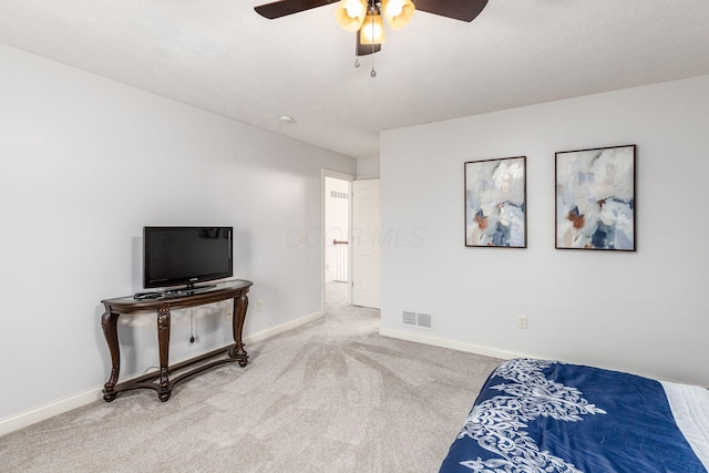 carpeted bedroom with a ceiling fan, baseboards, and visible vents