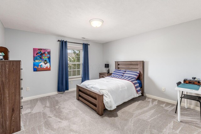 bedroom featuring baseboards and carpet