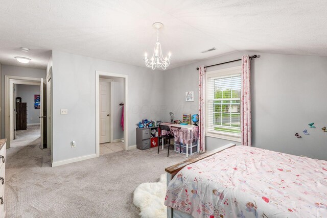 carpeted bedroom with a notable chandelier, a textured ceiling, baseboards, vaulted ceiling, and visible vents