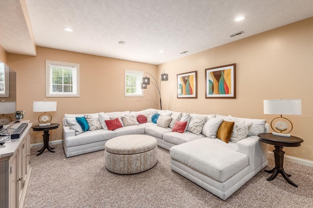 carpeted living area with baseboards, recessed lighting, and visible vents