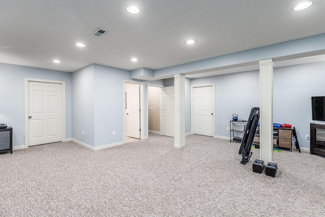 finished basement with carpet floors, recessed lighting, and visible vents