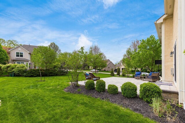 view of yard featuring a patio and a residential view