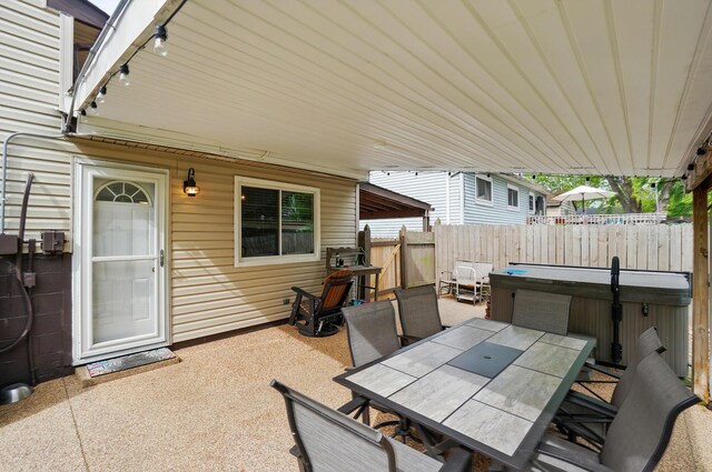 2680 Mellowbrook St, Columbus, OH 43232 - view of patio featuring a hot tub, outdoor dining space, and fence