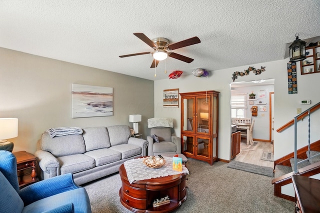 2680 Mellowbrook St, Columbus, OH 43232 - carpeted living area with ceiling fan, stairs, a textured ceiling, and baseboards