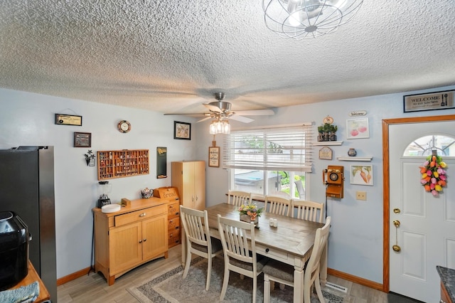 2680 Mellowbrook St, Columbus, OH 43232 - dining area featuring a textured ceiling, a ceiling fan, light wood-style flooring, and baseboards