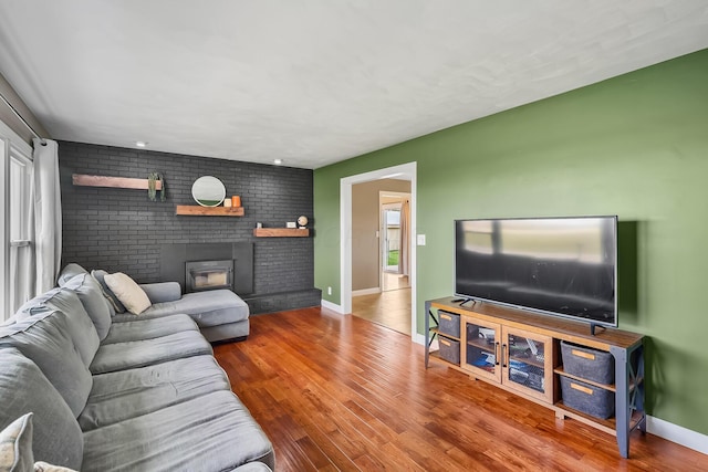 3877 Smeltzer Rd, Marion, OH 43302 - living area featuring a fireplace, wood finished floors, and baseboards