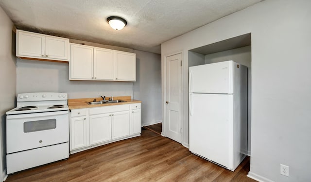 kitchen featuring a sink, white cabinetry, wood finished floors, white appliances, and light countertops