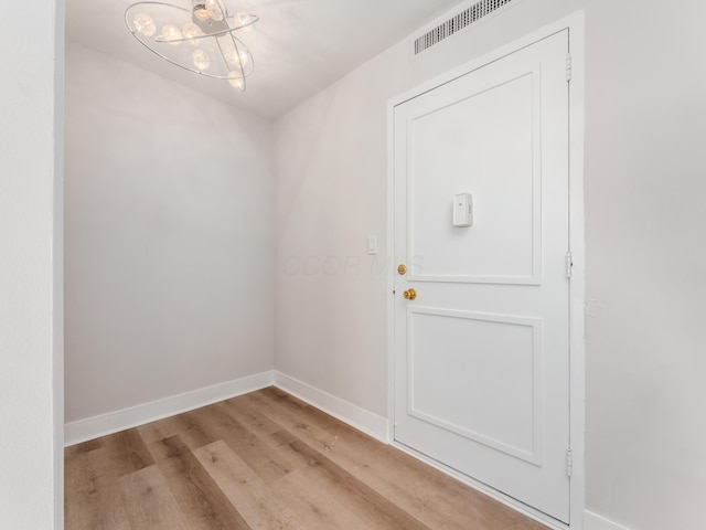 1620 E Broad St Unit 1106, Columbus, OH 43203 - doorway to outside with wood finished floors, a chandelier, and baseboards