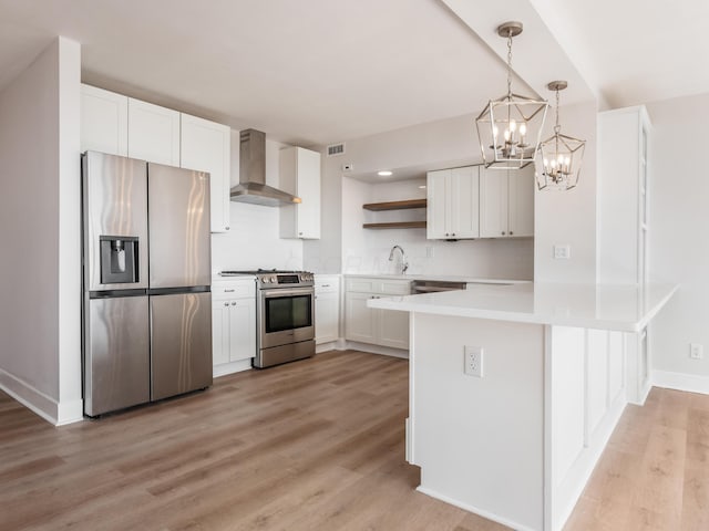 1620 E Broad St Unit 1106, Columbus, OH 43203 - kitchen featuring appliances with stainless steel finishes, wall chimney range hood, open shelves, a chandelier, and light wood-style flooring