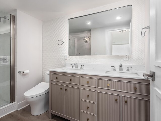 1620 E Broad St Unit 1106, Columbus, OH 43203 - bathroom featuring a shower stall, toilet, double vanity, and wood finished floors