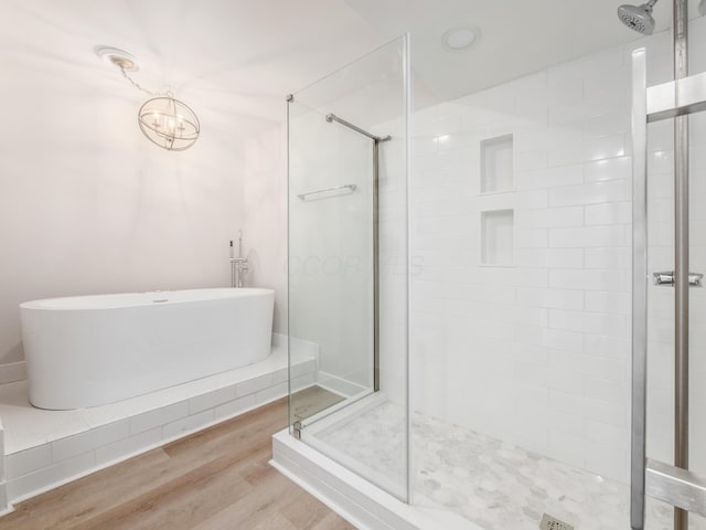 1620 E Broad St Unit 1106, Columbus, OH 43203 - bathroom featuring a stall shower, a soaking tub, and wood finished floors