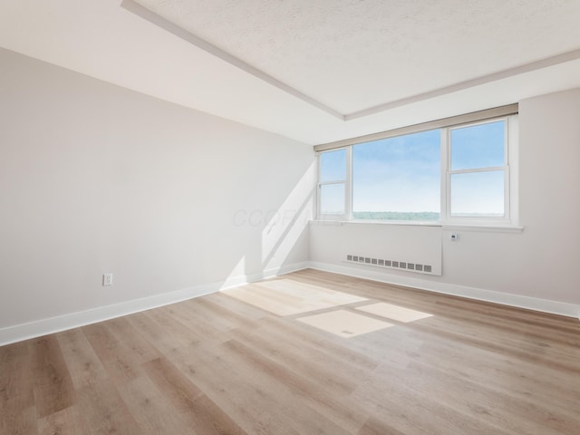 1620 E Broad St Unit 1106, Columbus, OH 43203 - empty room featuring wood finished floors, baseboards, and a textured ceiling