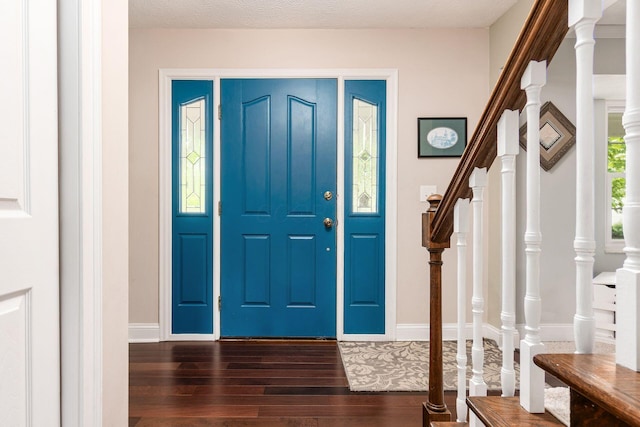 1123 Firth Ave, Worthington, OH 43085 - foyer entrance with dark wood-type flooring, stairs, and baseboards