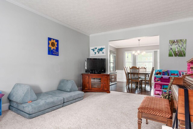1123 Firth Ave, Worthington, OH 43085 - carpeted living room featuring a chandelier, crown molding, and a textured ceiling