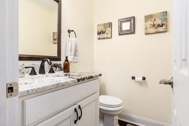 1123 Firth Ave, Worthington, OH 43085 - half bathroom featuring toilet, vanity, ornamental molding, and baseboards