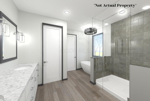 3031 Avalon Rd, Columbus, OH 43221 - full bathroom featuring a shower stall, wood finished floors, a freestanding tub, vanity, and recessed lighting