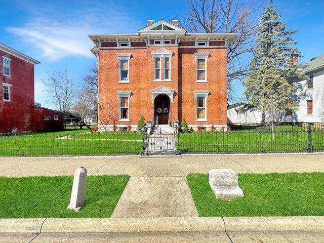 59 S Chillicothe St, South Charleston, OH 45368 - italianate home featuring a gate, a front lawn, brick siding, and a fenced front yard
